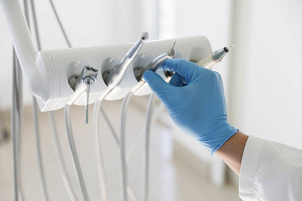 Professional Tooth Extraction technician working in Naples Manor, FL
